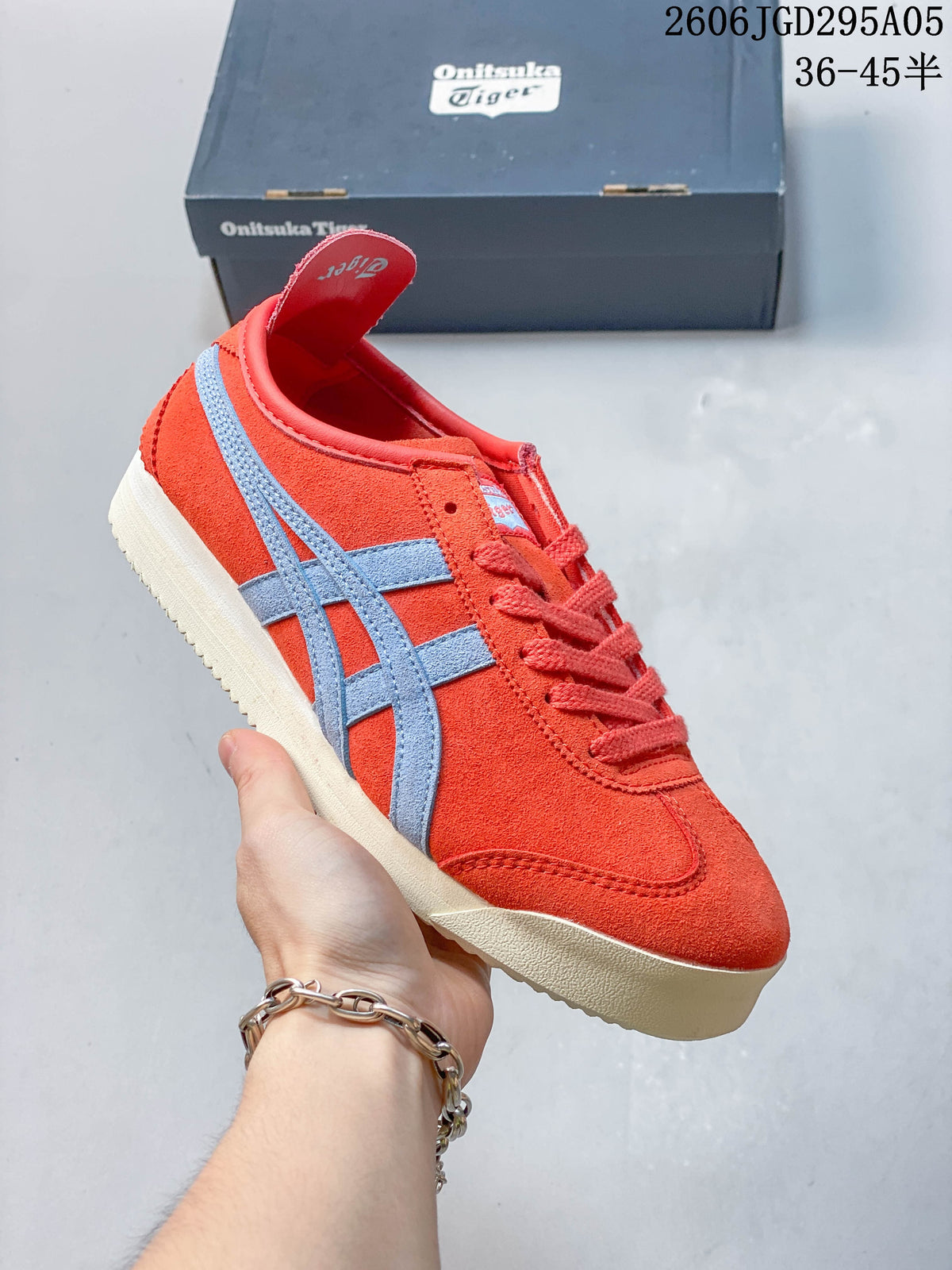 Red-orange low-top sneaker with pale blue side stripes