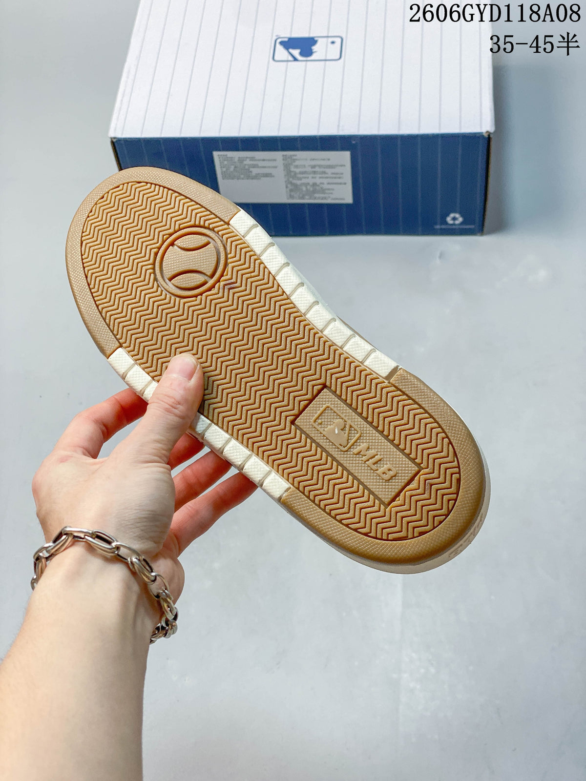 Close-up of the sneaker outsole with a herringbone tread pattern