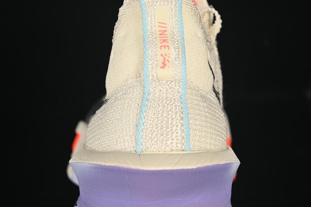 Rear view showing the heel tab, pale blue trim and purple heel section