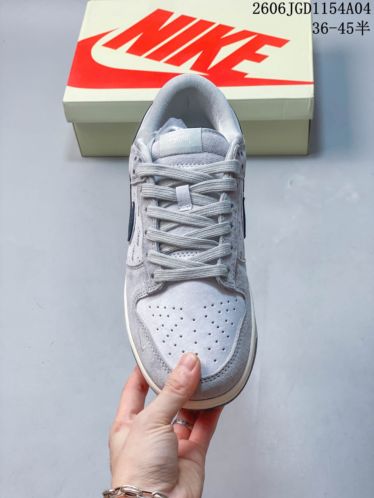 Top view of a grey low-top sneaker showing the laces and perforated toe box