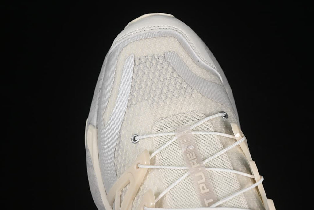 Toe-area detail showing the mesh-like upper, laces and protective overlays.