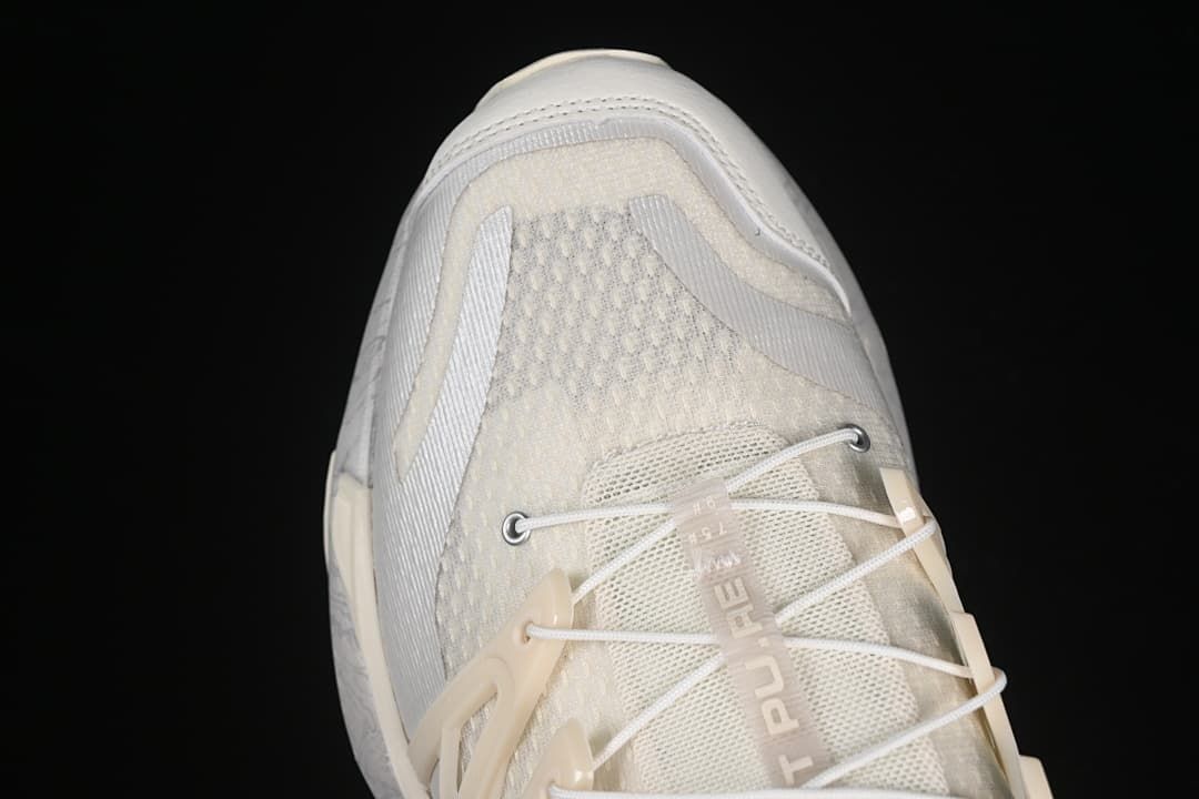 Toe-area detail showing the mesh-like upper, laces and protective overlays.