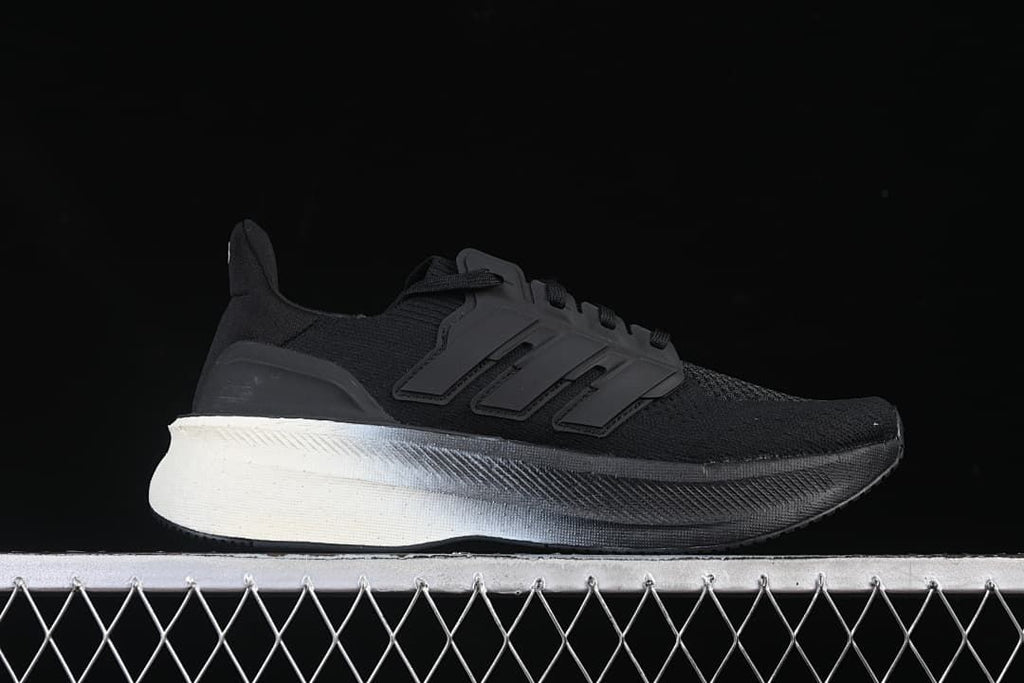 Side profile of a black sneaker with three-stripe detailing and a contrasting heel