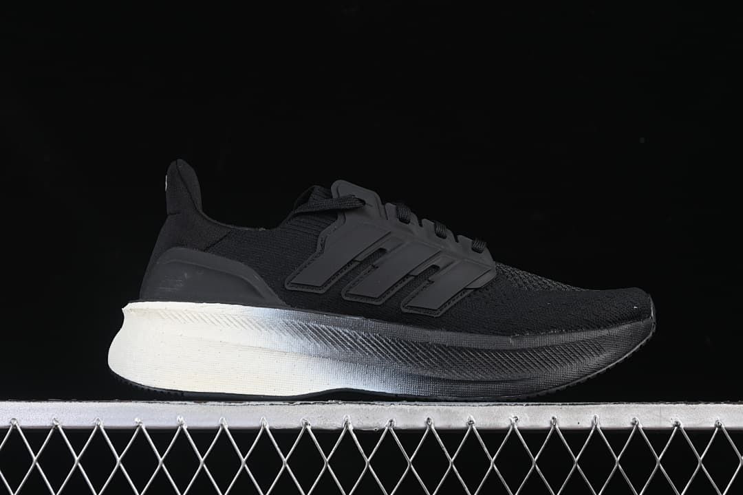 Side profile of a black sneaker with three-stripe detailing and a contrasting heel