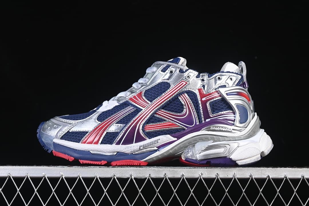 Side view of a navy, red, purple, silver and white Balenciaga Runner sneaker