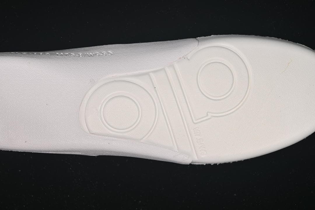 Close-up of the sneaker outsole with embossed circular details