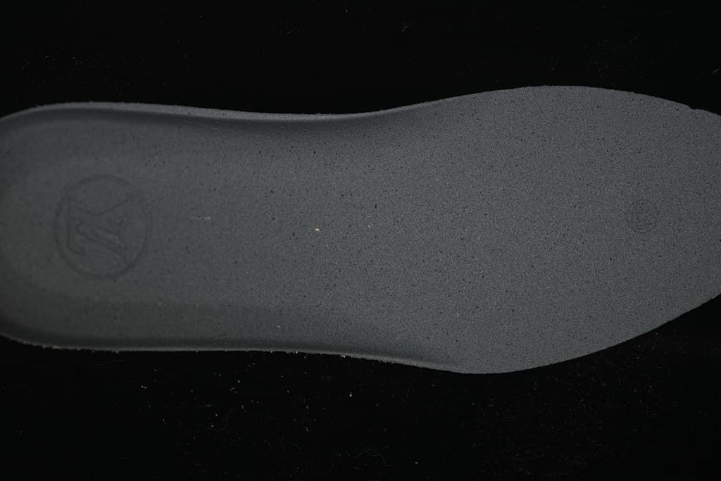 Close view of the sneaker's dark textured outsole.