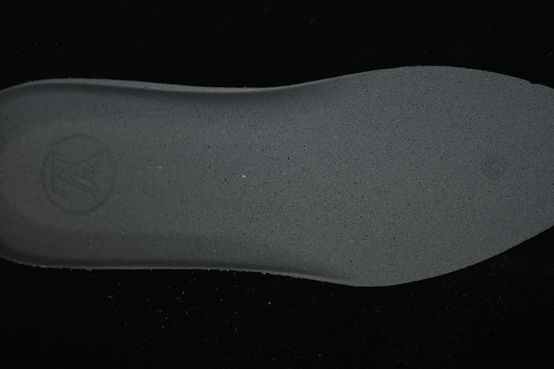 Close view of the sneaker's dark textured outsole.