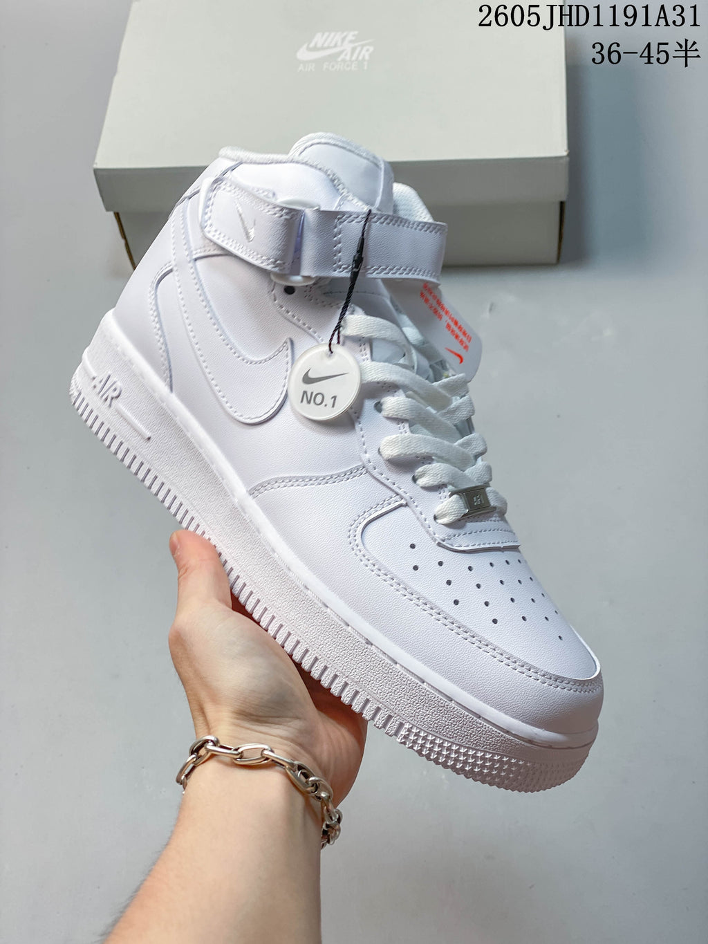 Angled view of a white high-top sneaker with Swoosh panel and textured outsole