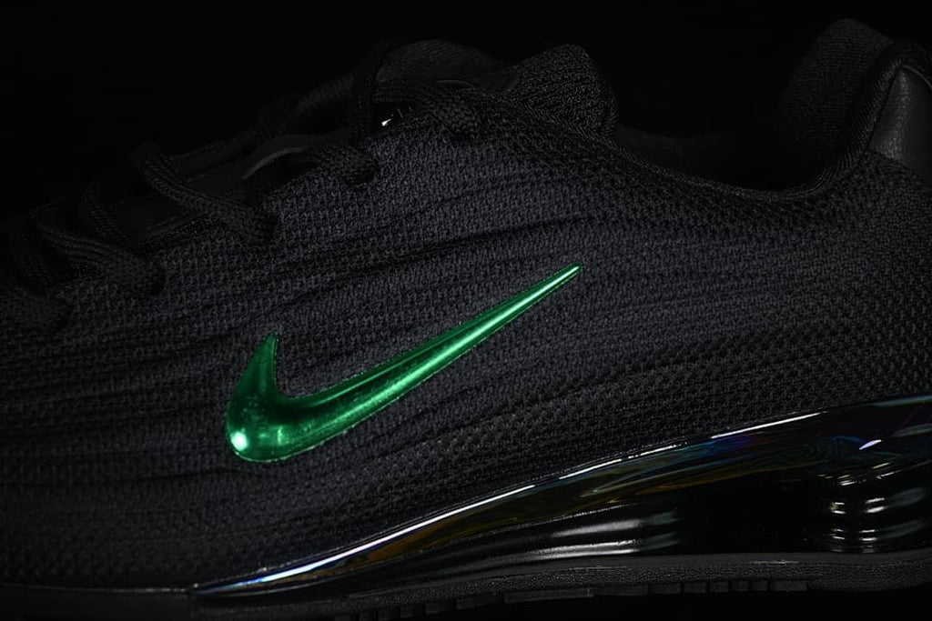 Close-up of the textured black upper, green Swoosh and heel cushioning.