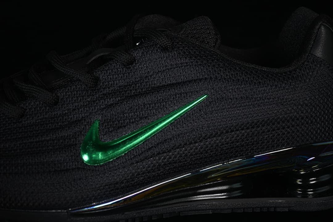 Close-up of the textured black upper, green Swoosh and heel cushioning.