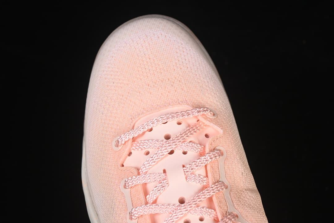 Top view of the pink mesh-look toe and lacing