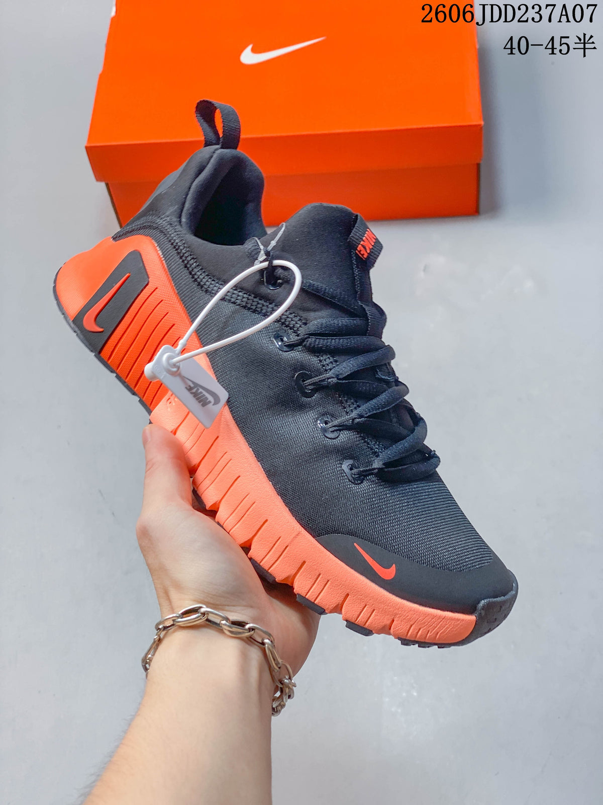 Angled side view highlighting the dark upper and bright orange sole