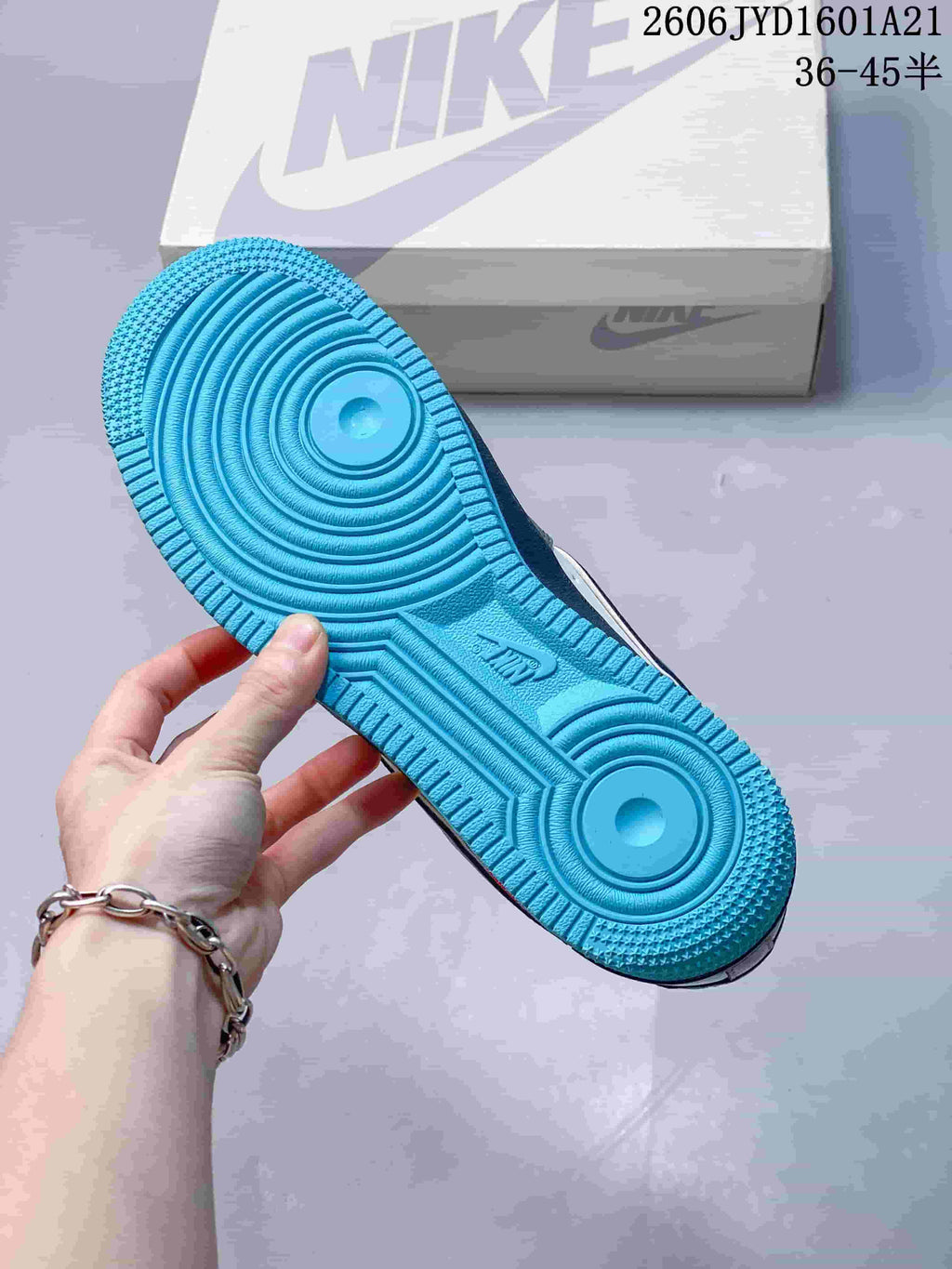 Bright blue outsole with circular tread patterns.