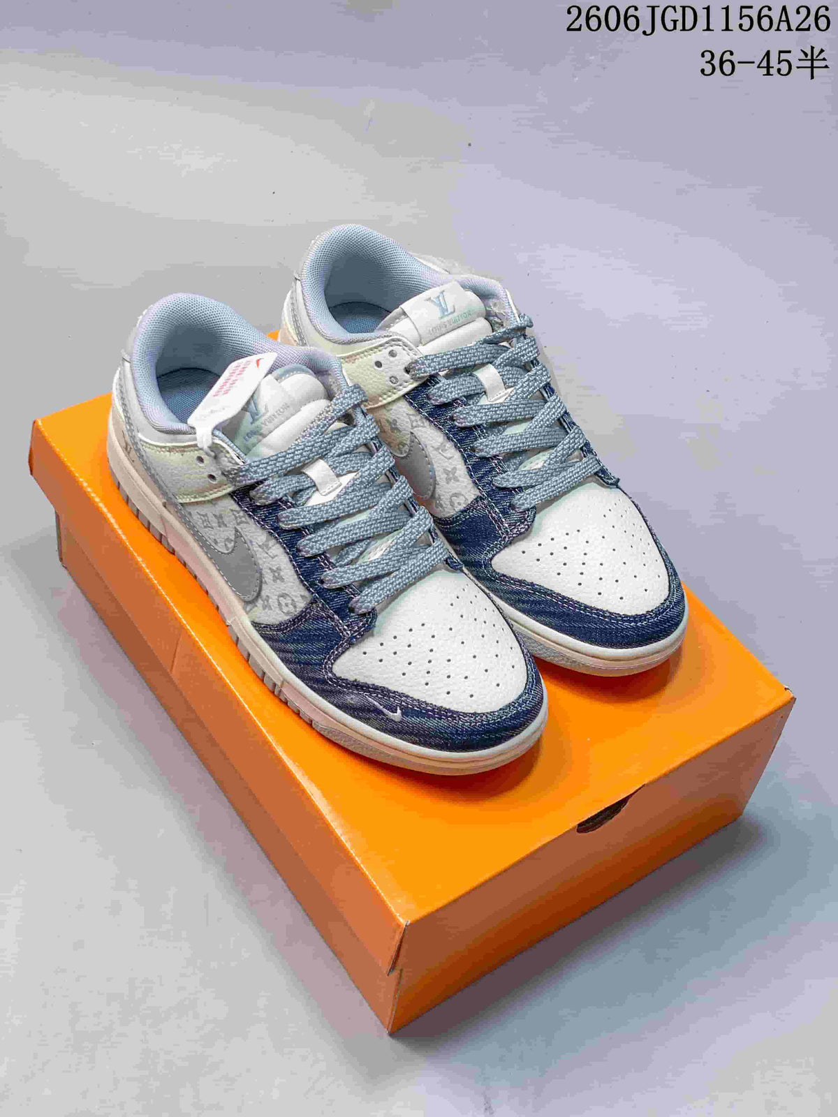 Pair of white low-top sneakers with blue denim-look overlays and patterned side panels