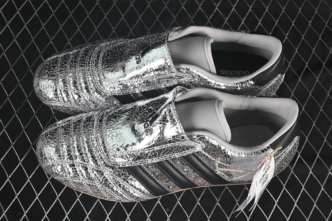 Pair of silver metallic adidas Taekwondo W shoes shown from above.