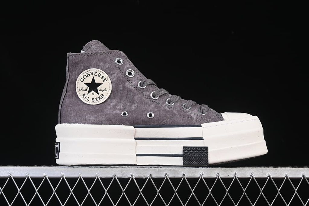 Side view highlighting the gray upper, ankle patch, and thick platform sole.