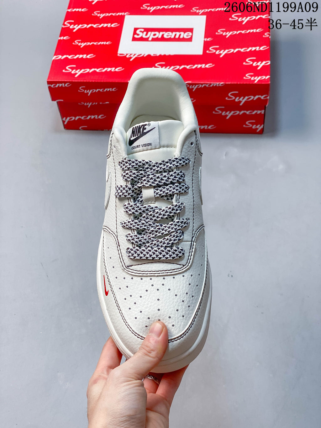 Top view of the sneaker showing perforated toe, patterned laces, and tongue label reading Court Vision.