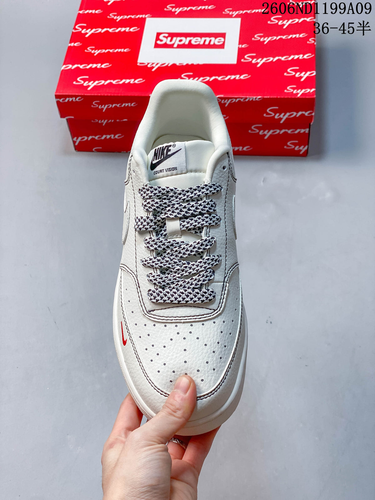 Top view of the sneaker showing perforated toe, patterned laces, and tongue label reading Court Vision.