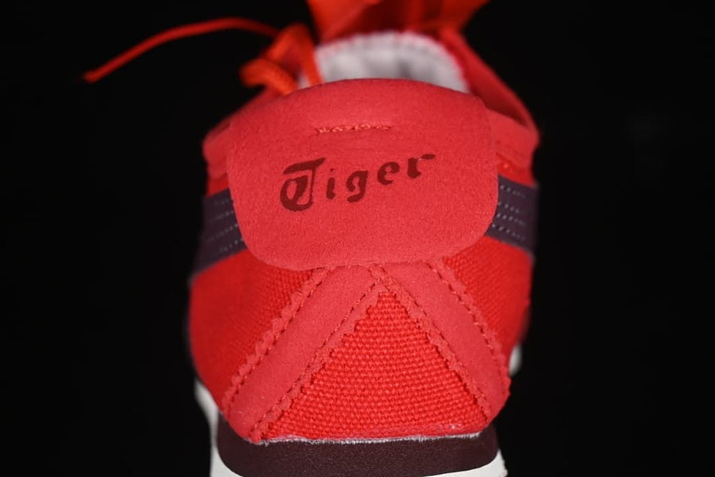 Rear view of the red sneaker with Tiger branding on the heel tab