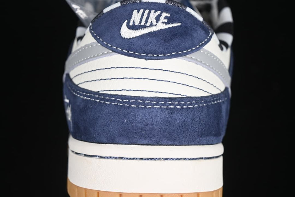 Rear view of the sneaker with navy, grey, and white panels
