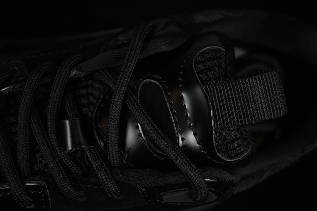 Close-up of the sneaker's black laces, tongue, and pull tab.