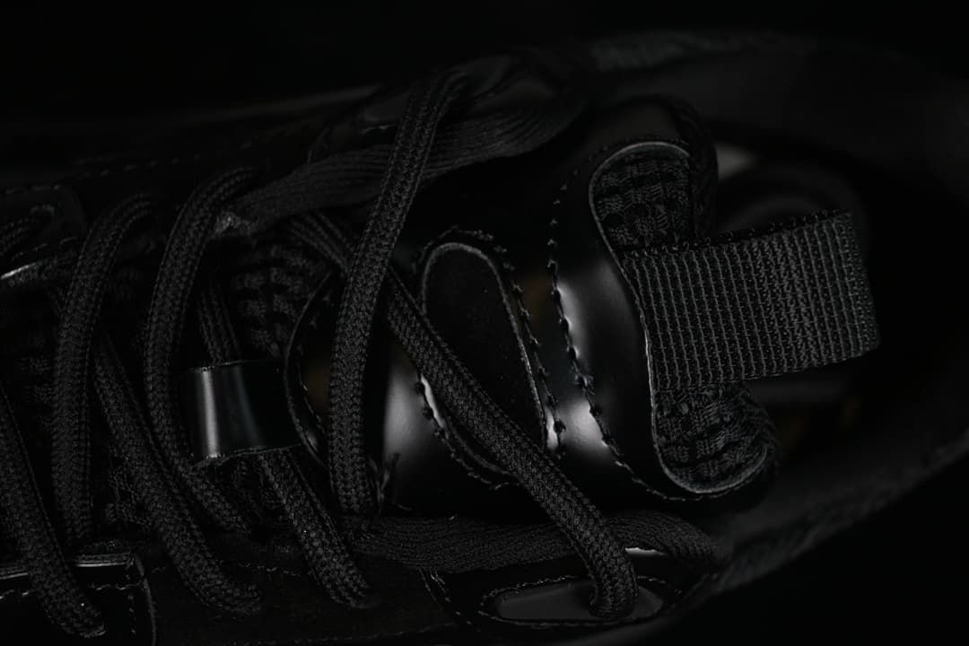 Close-up of the sneaker's black laces, tongue, and pull tab.