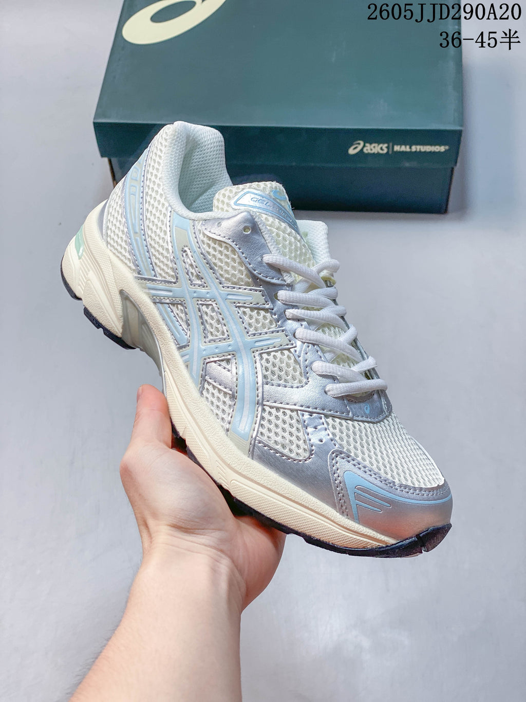 Angled side view of the silver and pale blue ASICS GEL-1130 sneaker