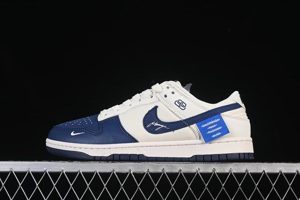 Side profile of cream and navy low-top sneakers