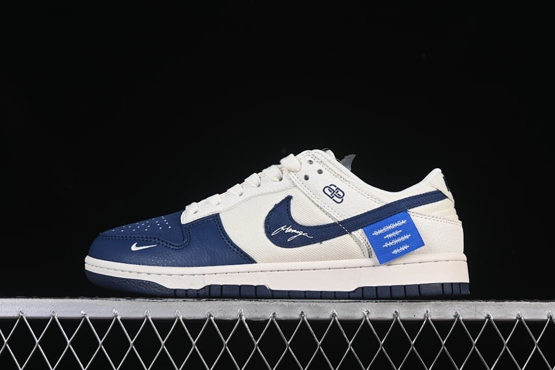 Side profile of cream and navy low-top sneakers