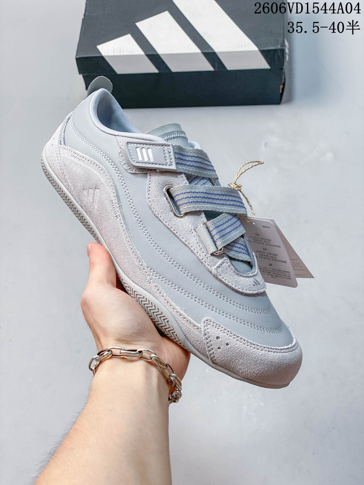 Angled side view of the light gray Adidas Urban Reverie sneaker and strap details