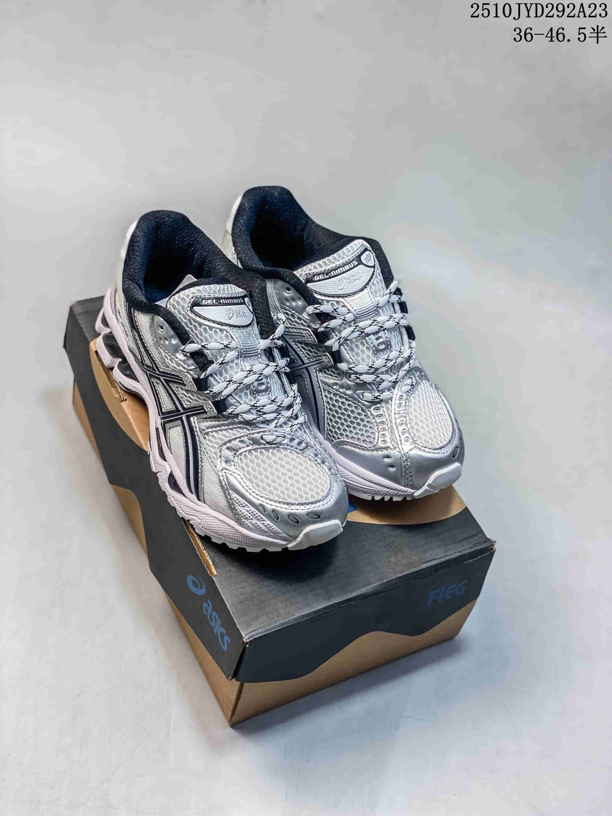 Pair of silver and white ASICS GEL-Nimbus sneakers displayed on a shoebox