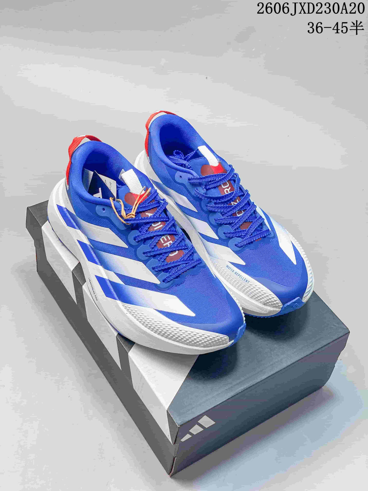 Pair of blue, white, and red Adidas Adizero Evo SL running shoes on a shoe box