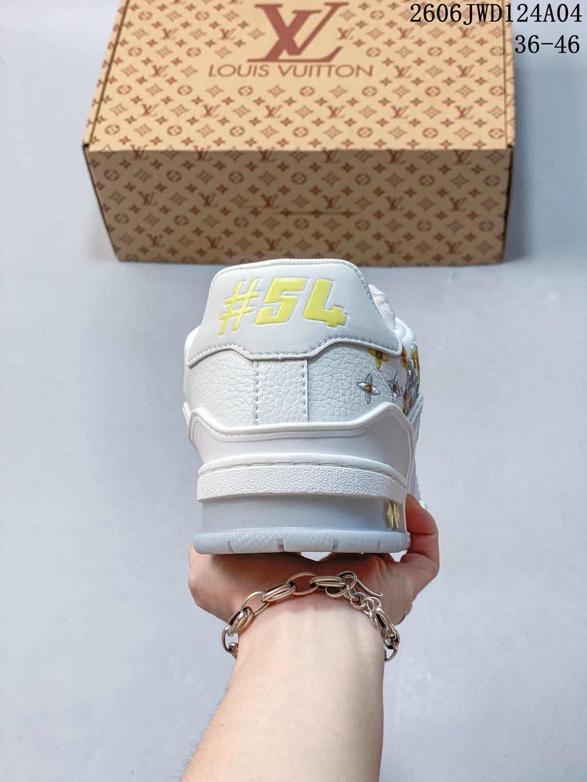 Rear view of a white sneaker showing a yellow #54 heel detail and floral embroidery at the side.