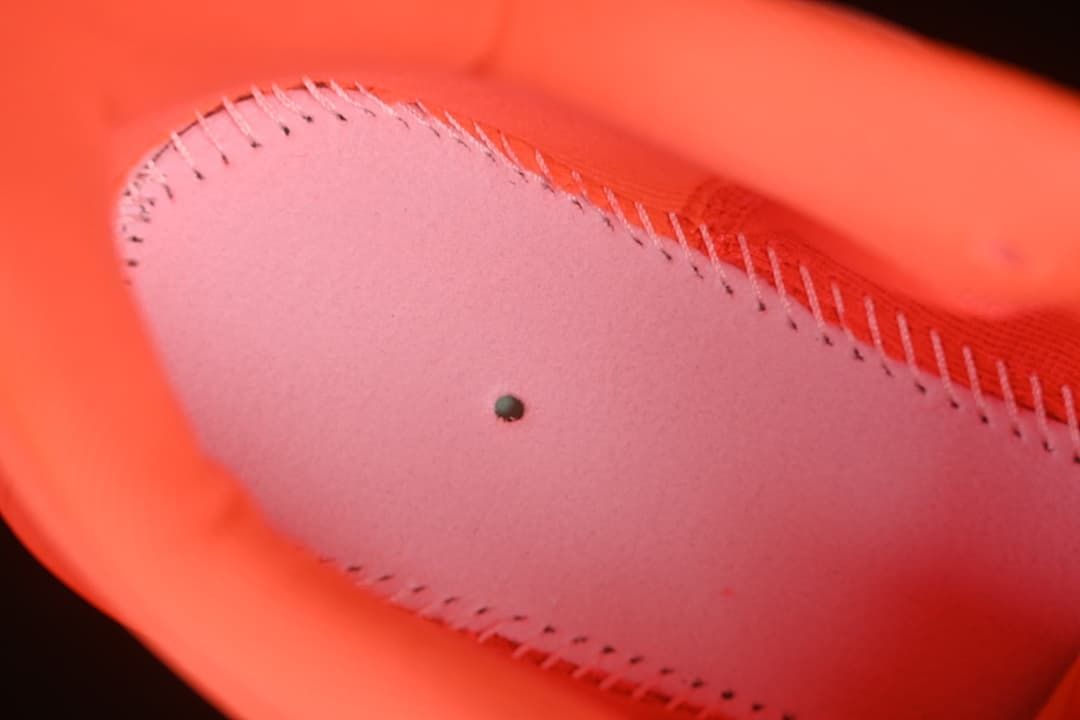 Close-up of stitching and lining inside the coral running shoe