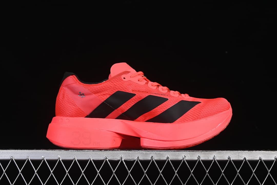 Side profile of a coral running shoe with black stripes