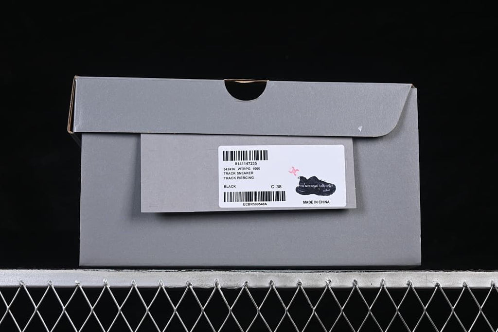 Shoebox label identifying Track Sneaker, Track Piercing, black and size C 38