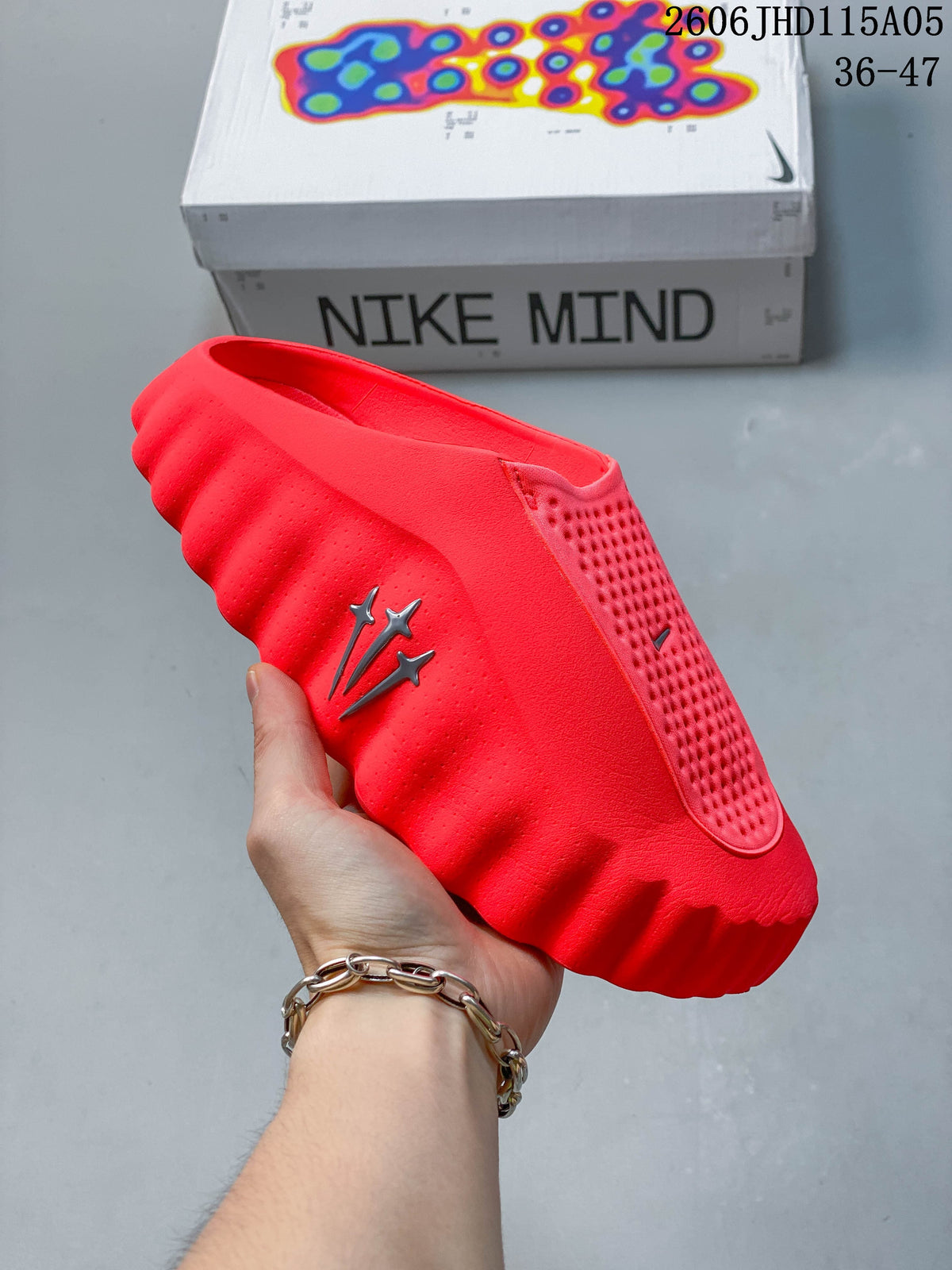 Bright red Nike Mind slide shown from the side