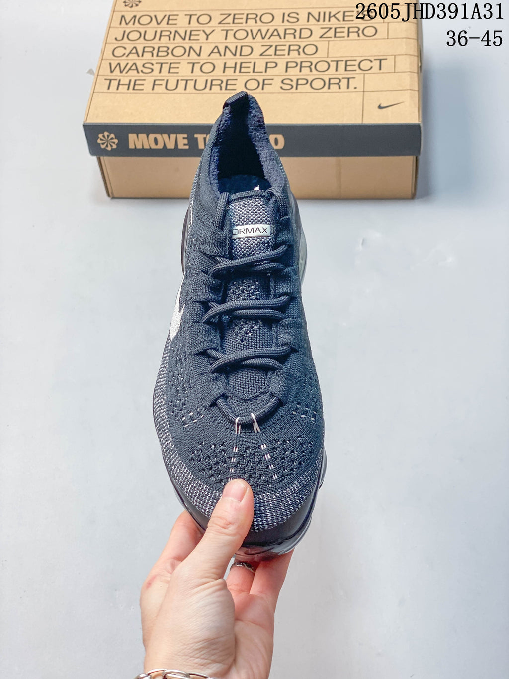 Front view showing the knit upper and laces of a Nike Air VaporMax shoe