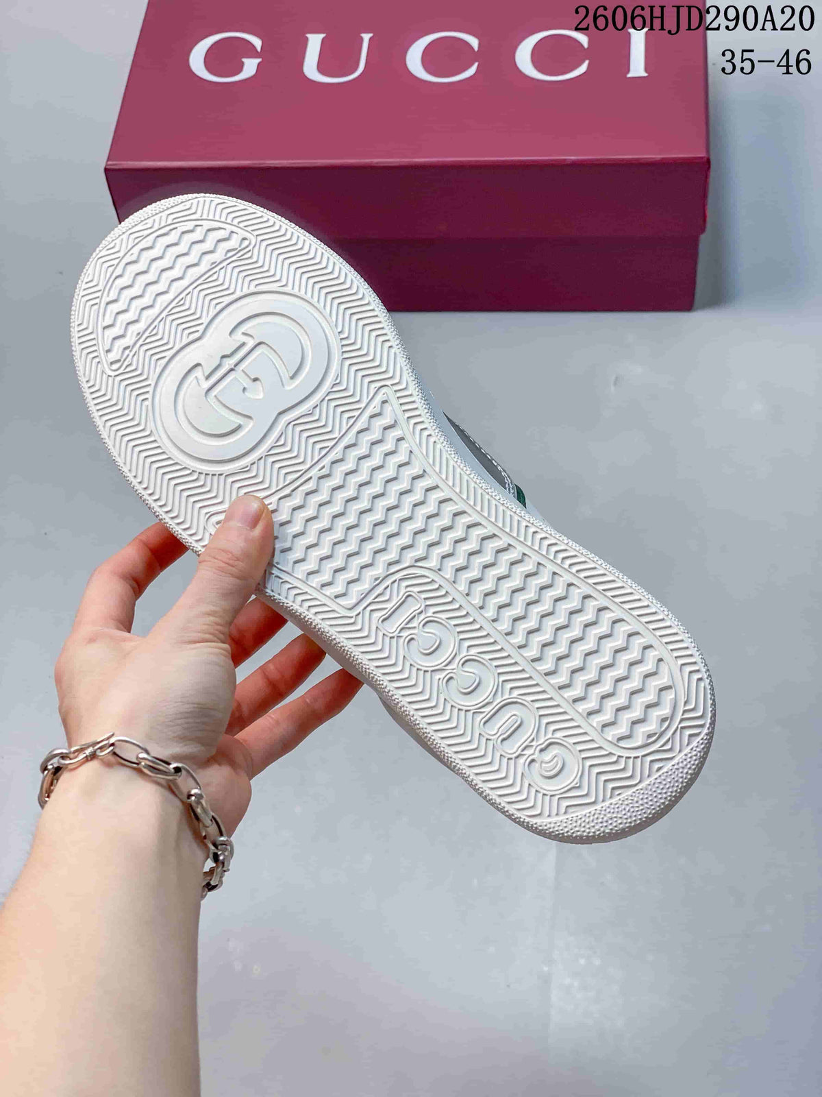 Underside of a white sneaker showing a patterned outsole