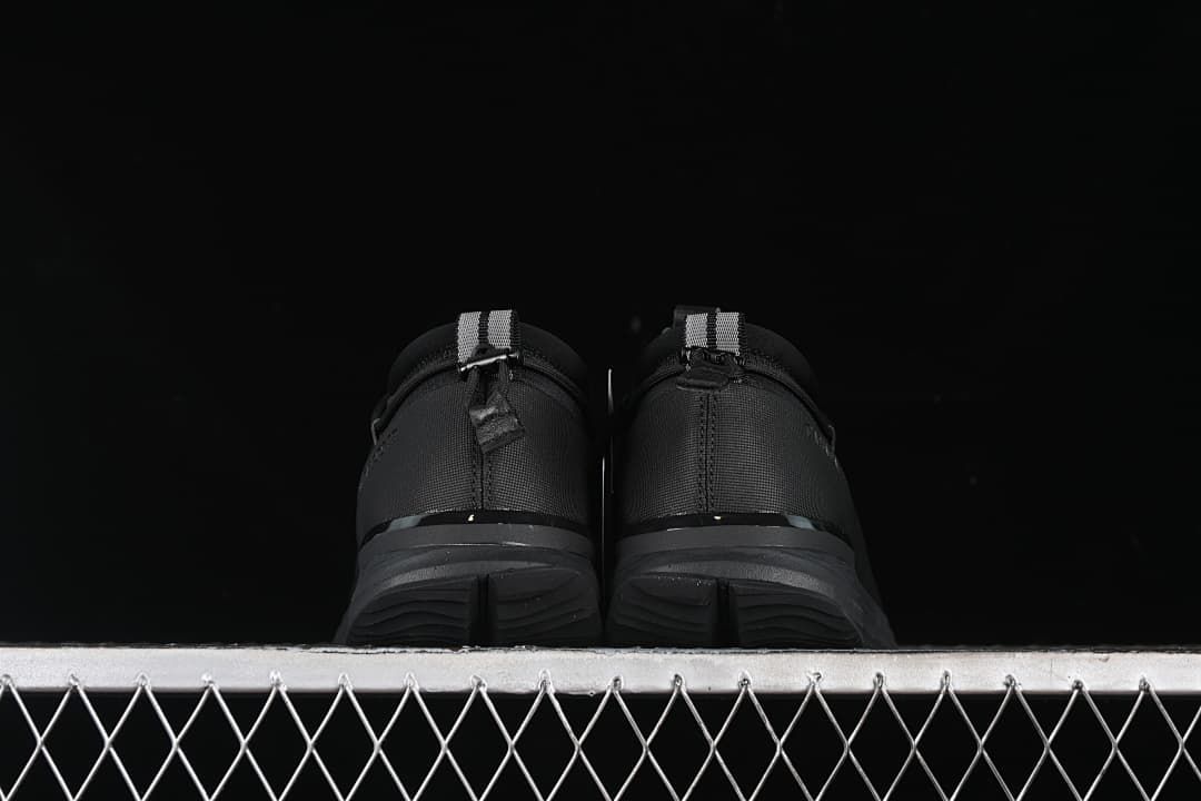 Rear view of both sneakers showing heel tabs and outsoles