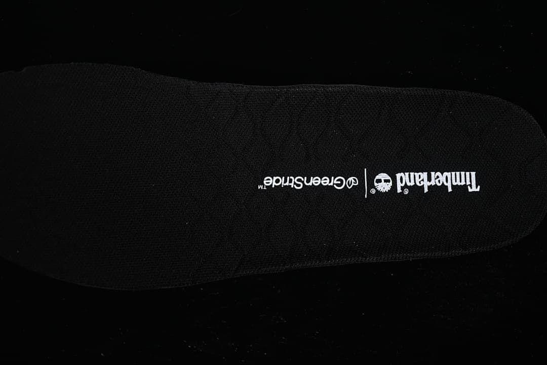 Close-up of the black footbed printed with Timberland GreenStride branding