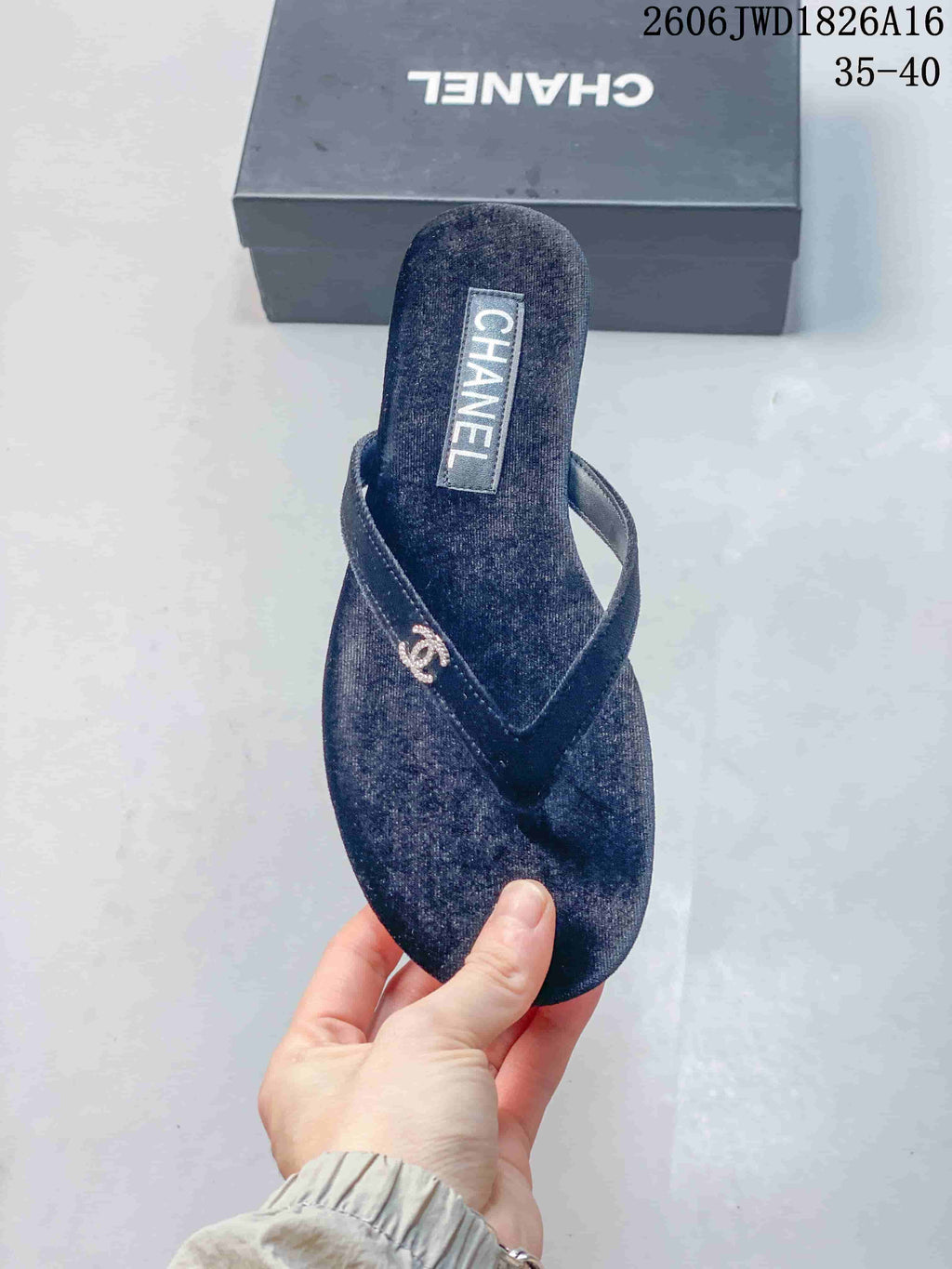 Top view of a navy thong sandal with textured footbed and metallic strap detail.