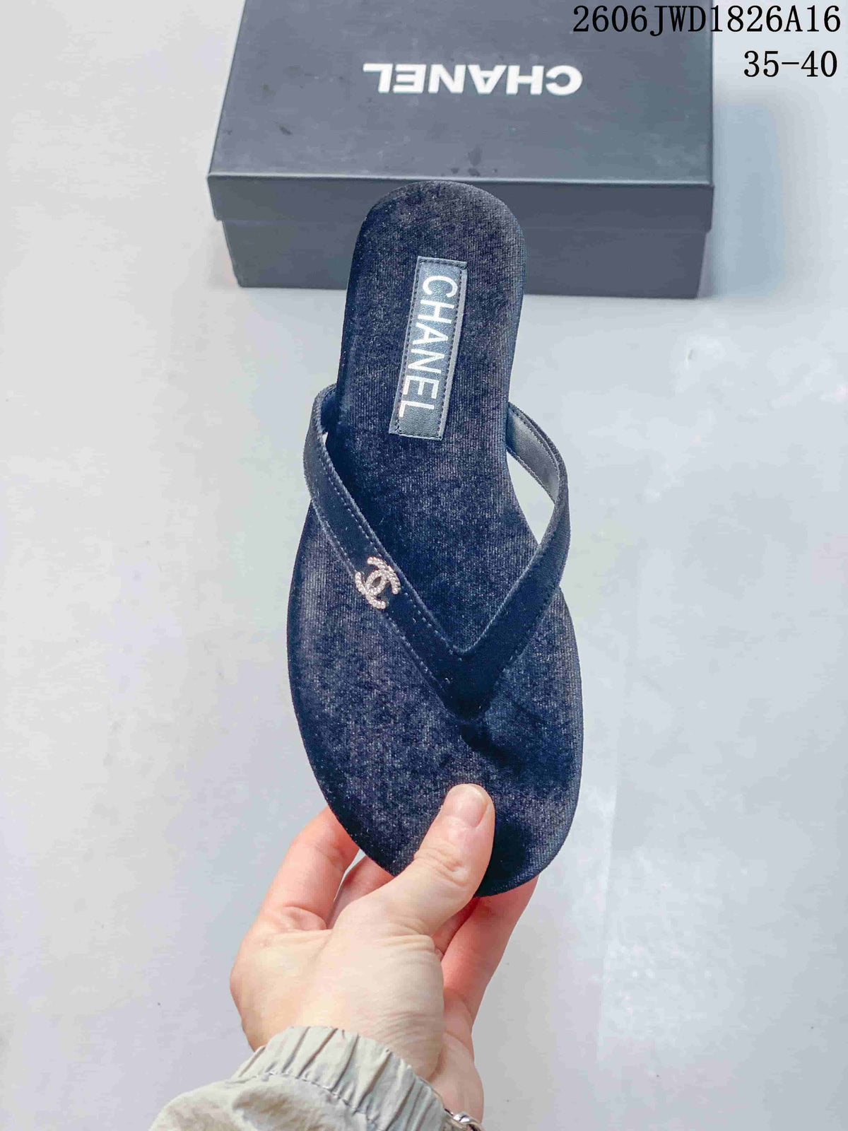 Top view of a navy thong sandal with textured footbed and metallic strap detail.