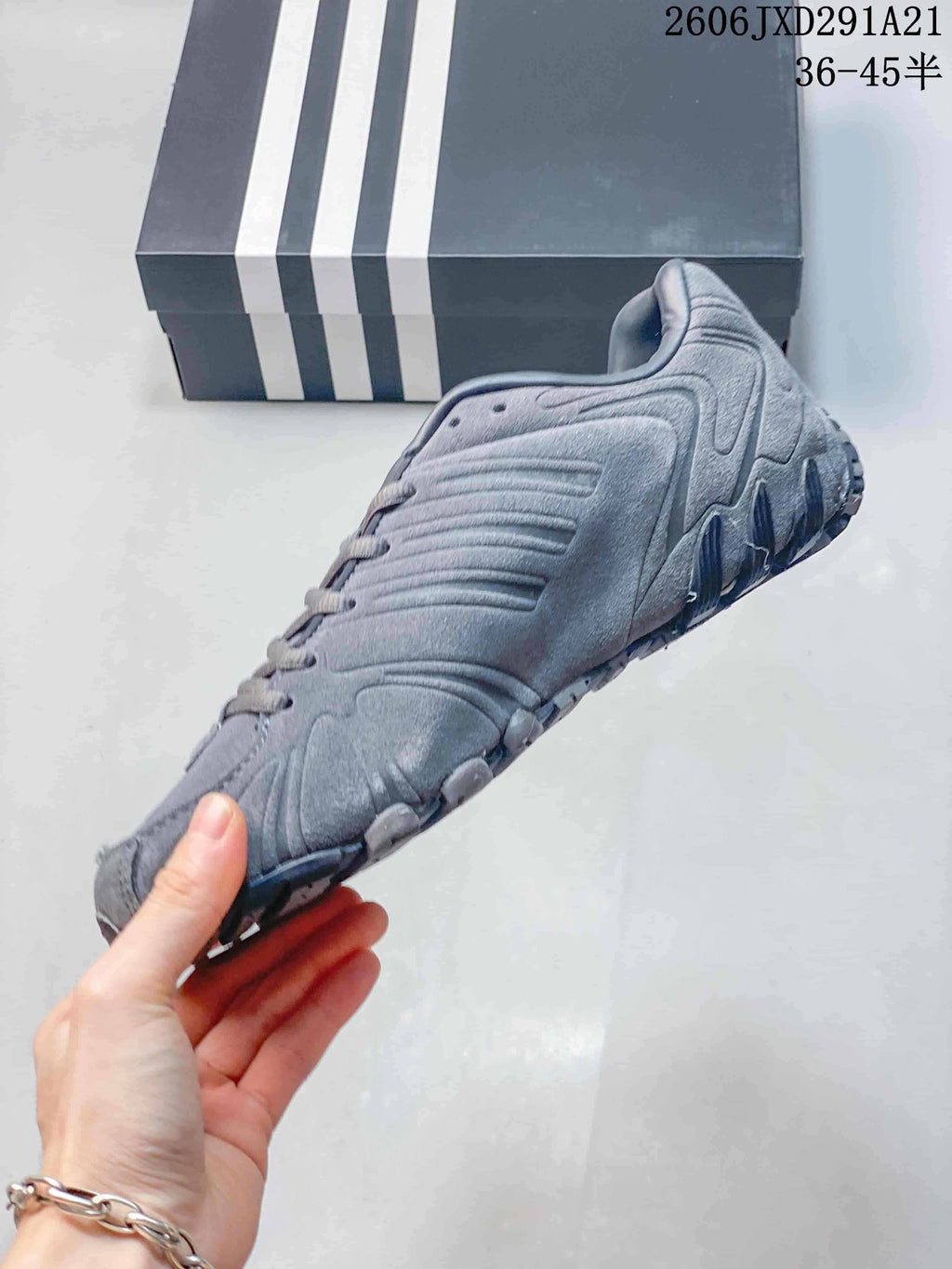 Side view of a gray adidas Ghost Sprint sneaker with layered upper detailing.