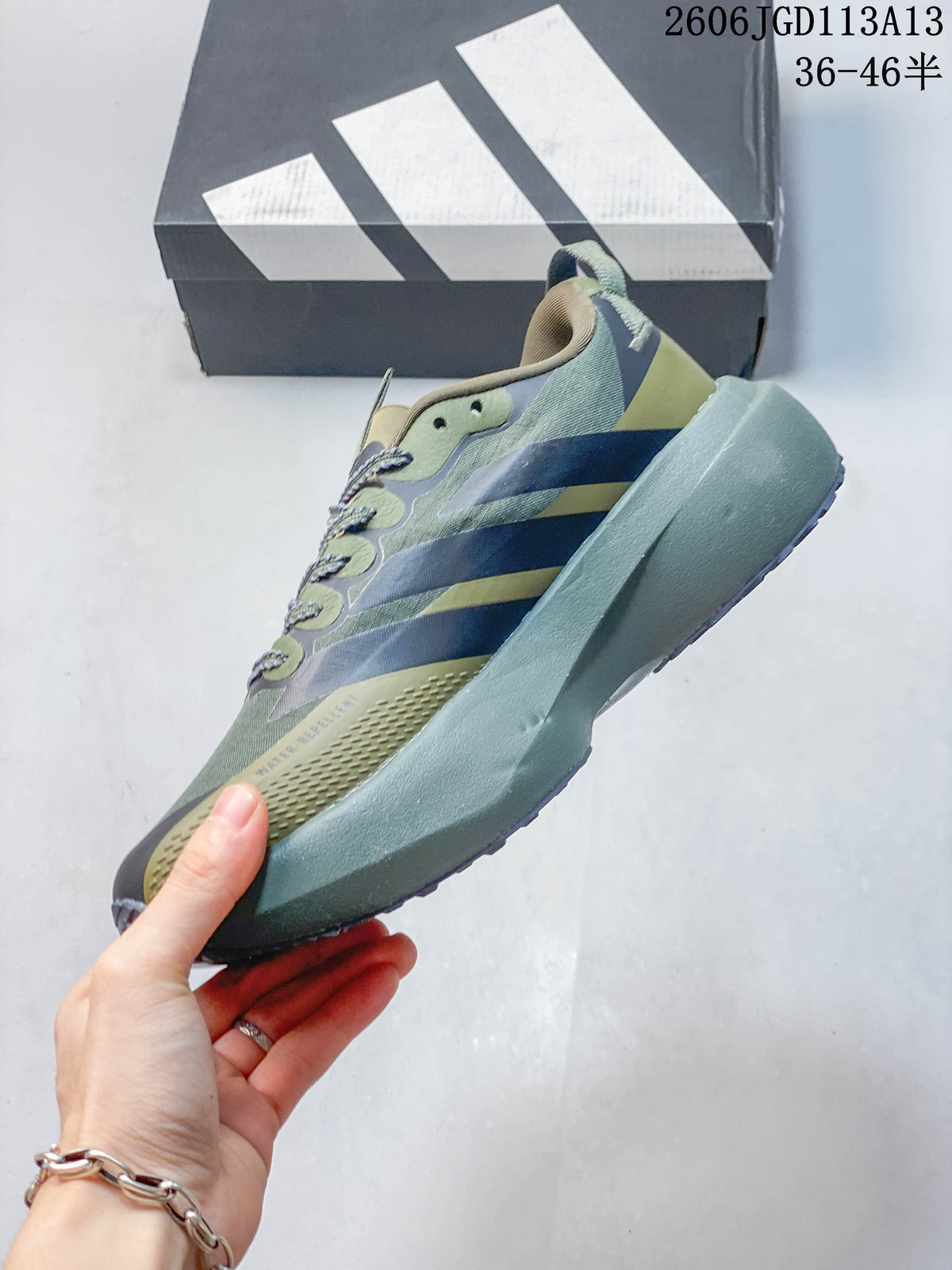 Side profile of an olive, gray, and muted yellow low-top running shoe