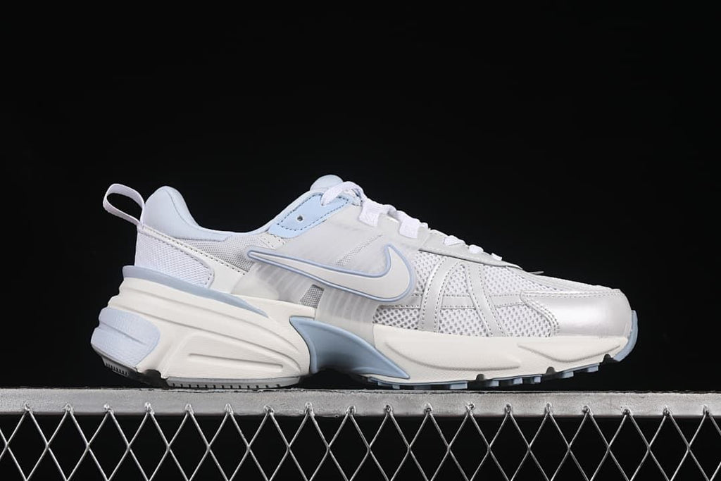 Side profile of a white and pale blue Nike V2K Run sneaker