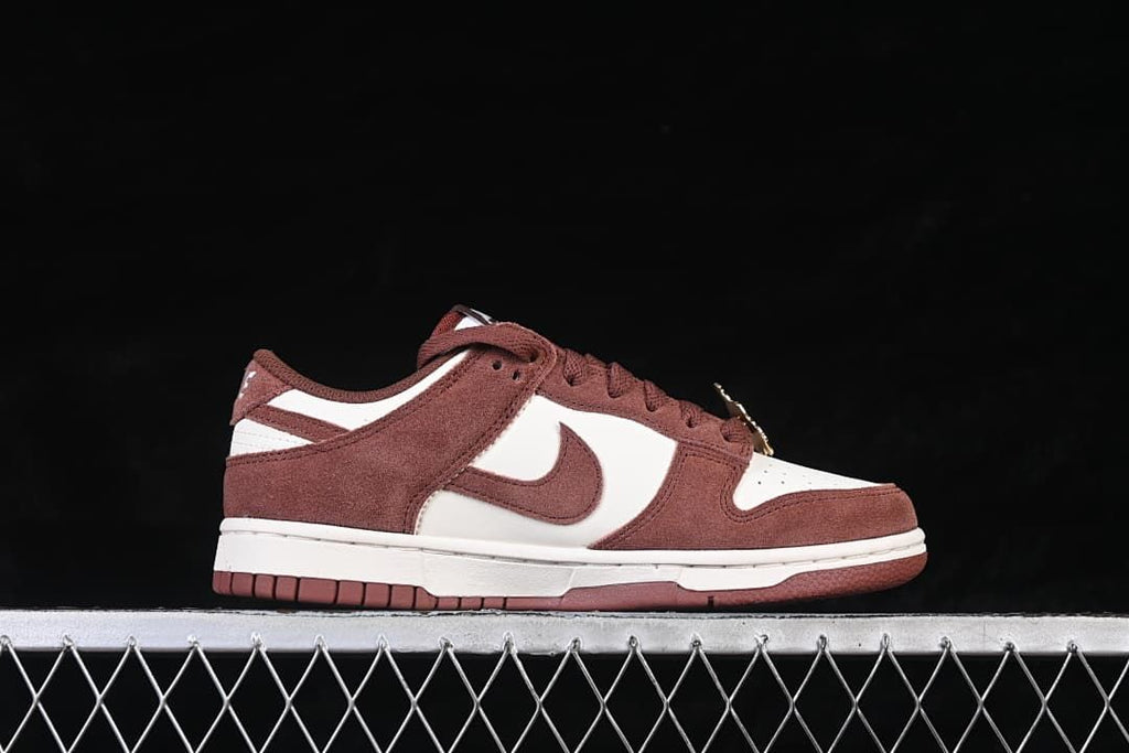 Side profile showing the low-top silhouette and brown and white color blocking