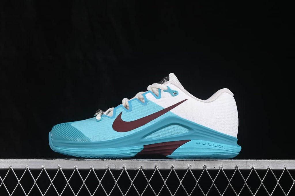 Opposite side profile showing the aqua upper, white heel section and burgundy Swoosh.