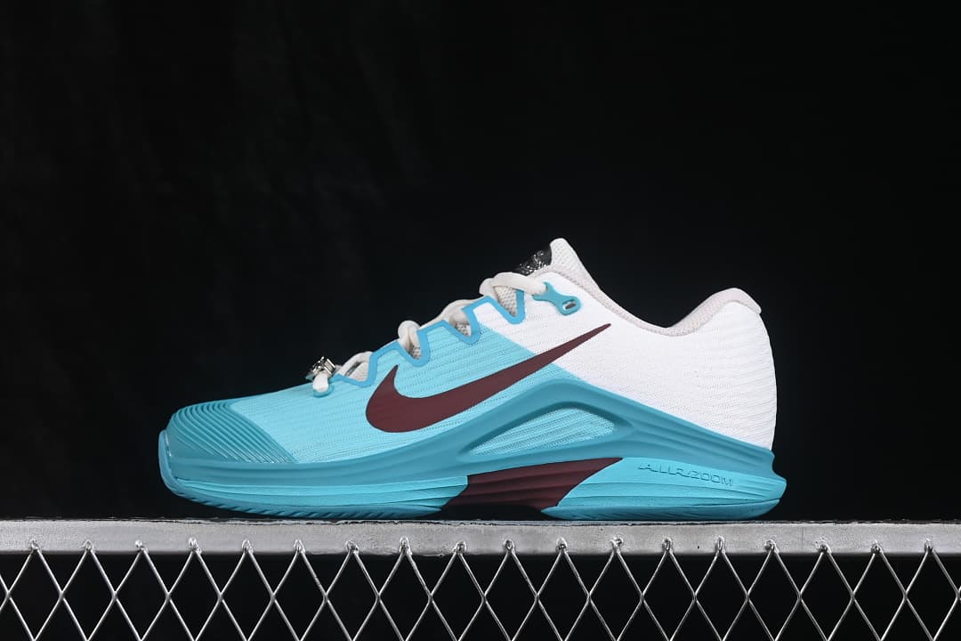Opposite side profile showing the aqua upper, white heel section and burgundy Swoosh.